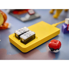 Close-up of a yellow toy device with metallic components on a blue surface.