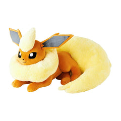 Plush toy of a fox-like creature with yellow fur and brown accents on a white background