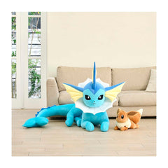 Large blue and white plush toy with a smaller brown and white plush toy on a wooden floor.