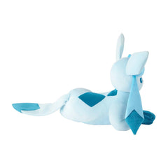 A light blue and teal plush toy resembling a stylized rabbit or dragon, posed lying down on a plain white background.