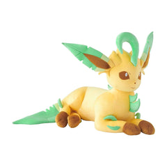 Plush toy of a yellow creature with green leaves on a white background