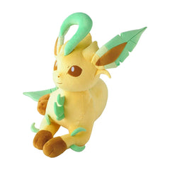 A plush toy of the character Eevee, featuring its signature yellow fur, mint green accents, and brown paws and inner ears, set against a plain white background.