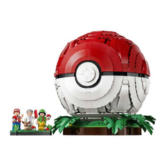 A building-block style Pokéball display on a pedestal with green leaves, shown alongside small minifigures on a plain white background.