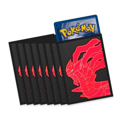 Pokémon trading card with a red dragon design on a black card, surrounded by additional black cards.